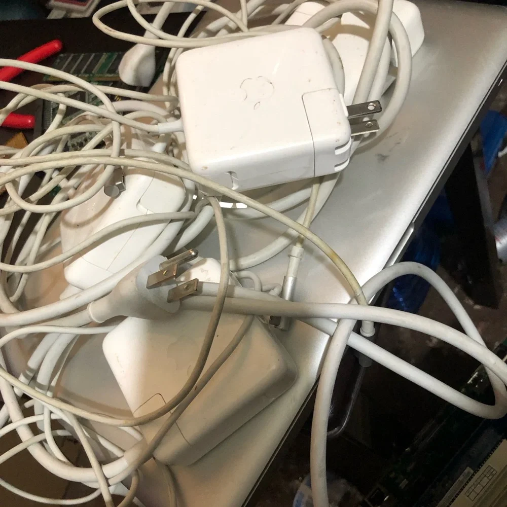 Apple MacBook with 4 chargers and dell laptop for parts
